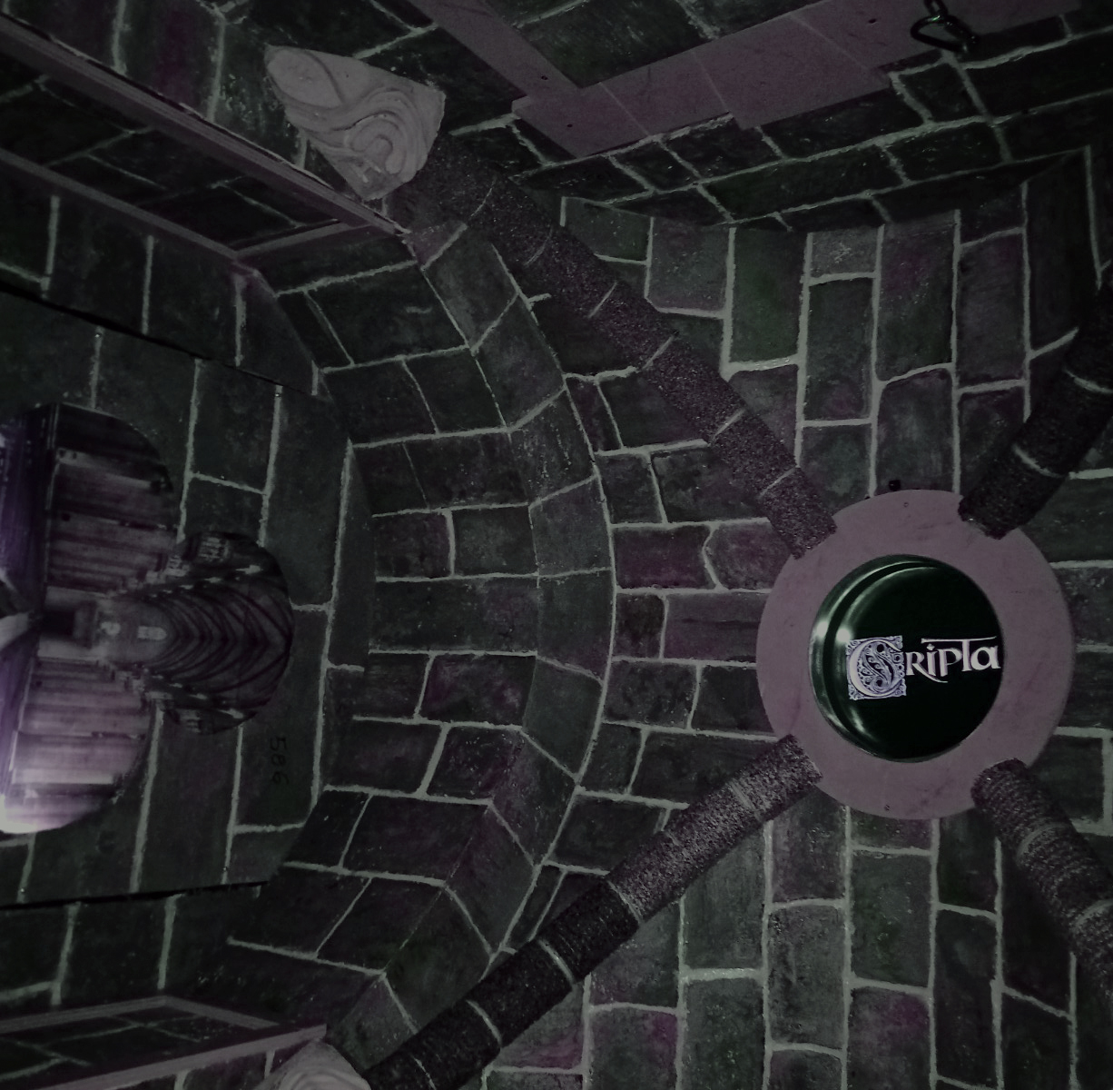 Interni Escape Room Cripta Milano: soffitto gotico scenografico e logo Clues Hunt, l'esperienza ideale per famiglie e bambini